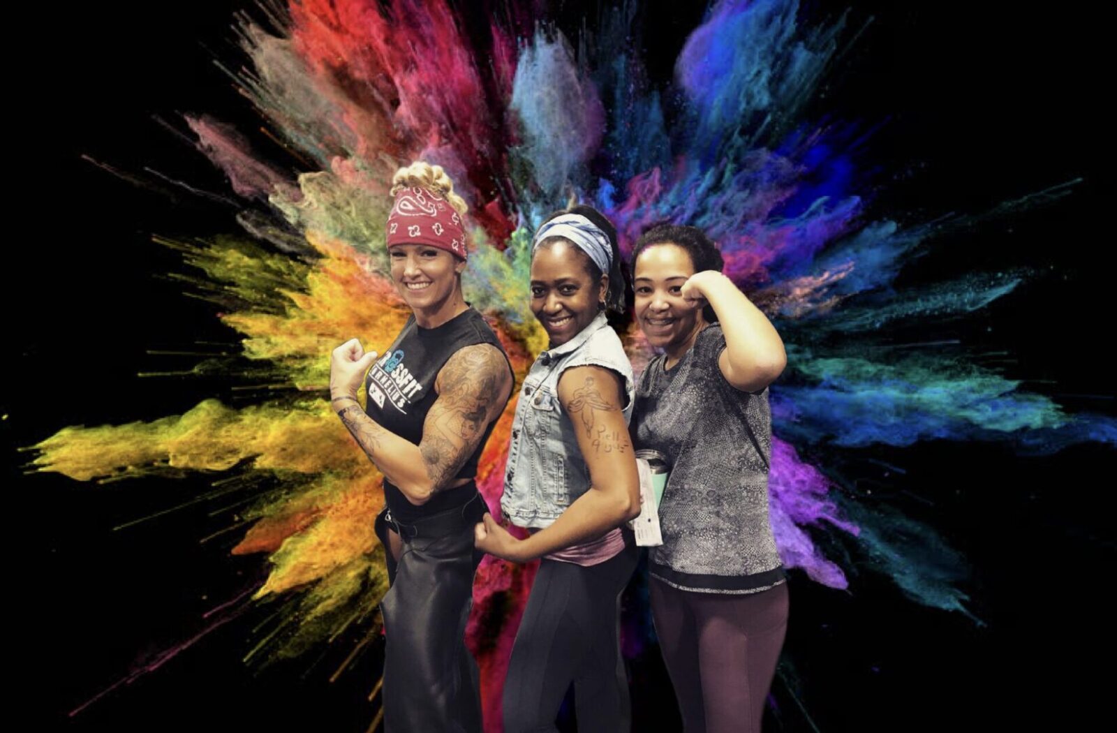 Three women posing in front of a colorful background.