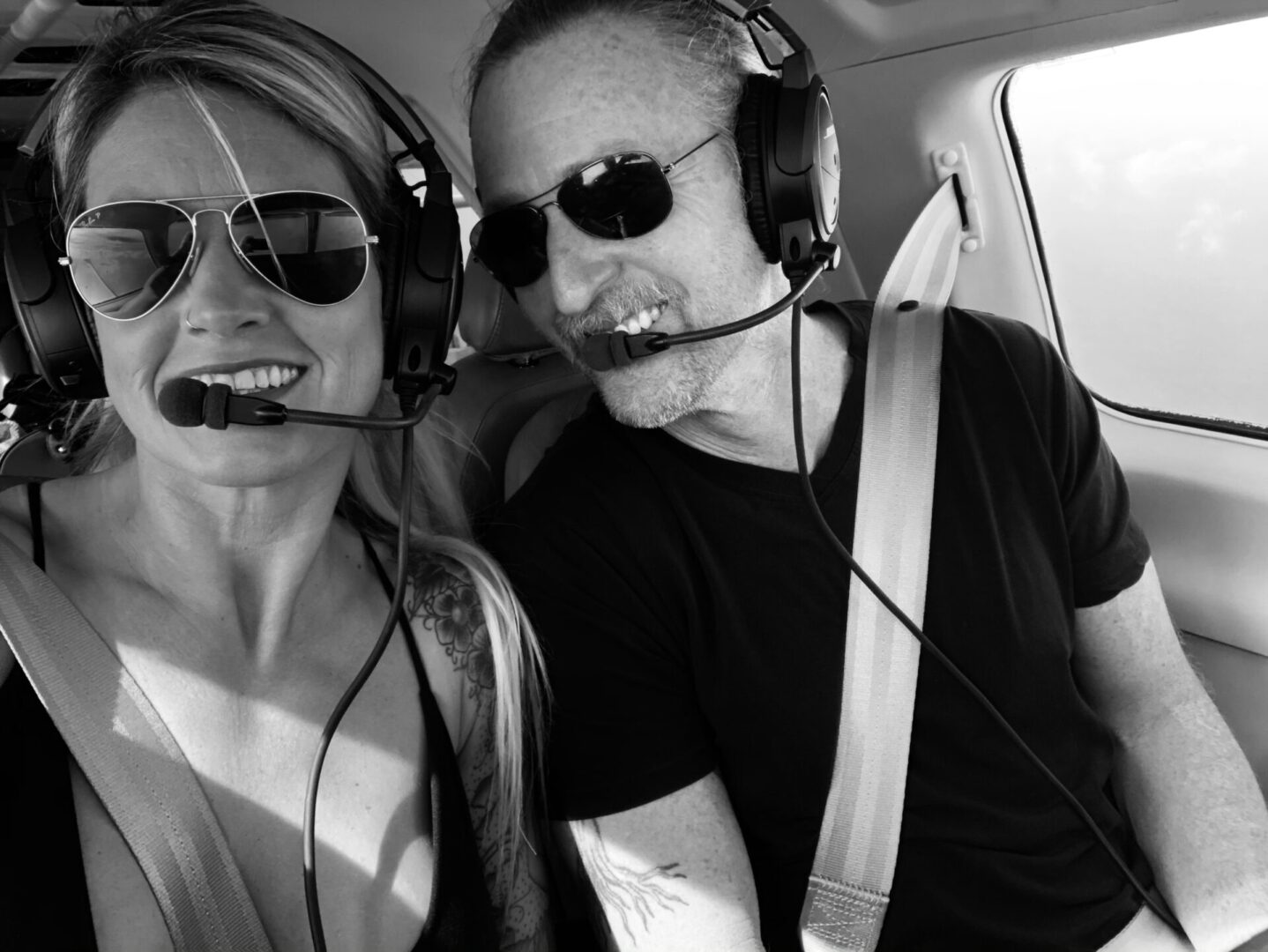 A man and woman in the back of an airplane.