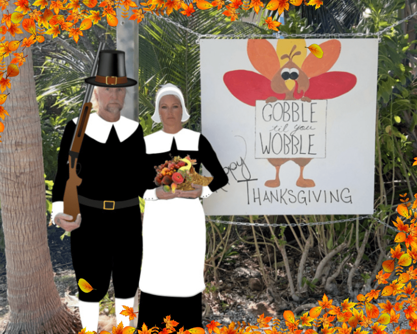 A couple dressed as pilgrims standing in front of a sign.